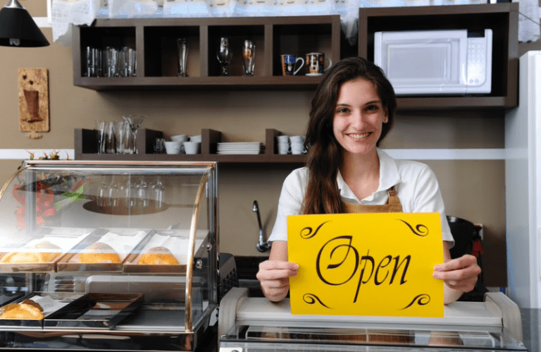 business owner holding an open sign