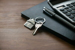 Real estate financials, calculator and keys on a desk